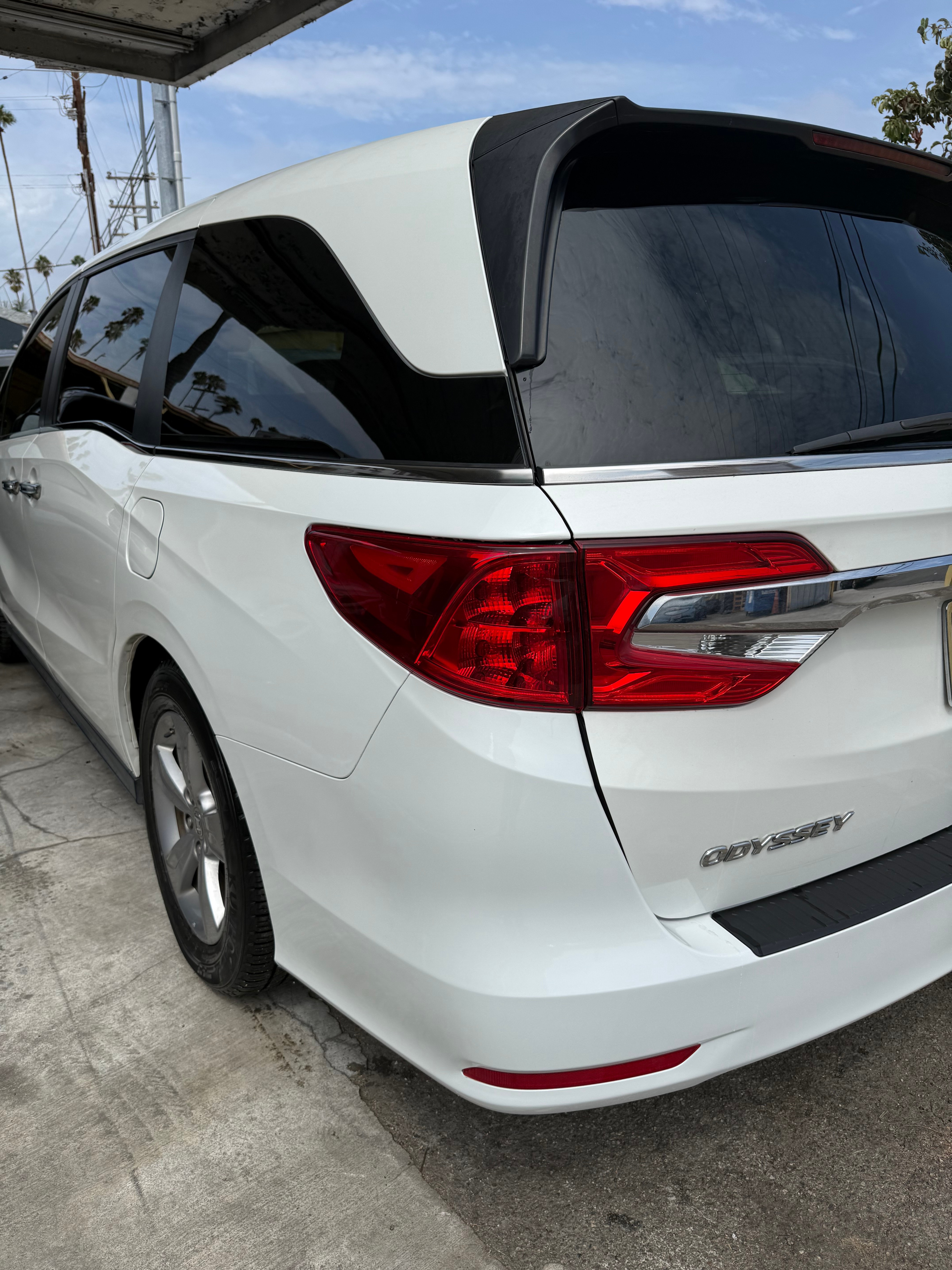 After: white Honda Odyssey rear quarter panel and bumper repair