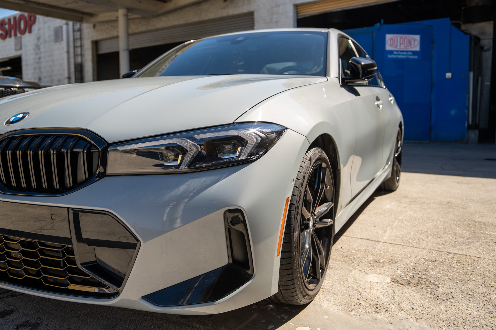 After: gray BMW 330i front bumper and headlight collision repair