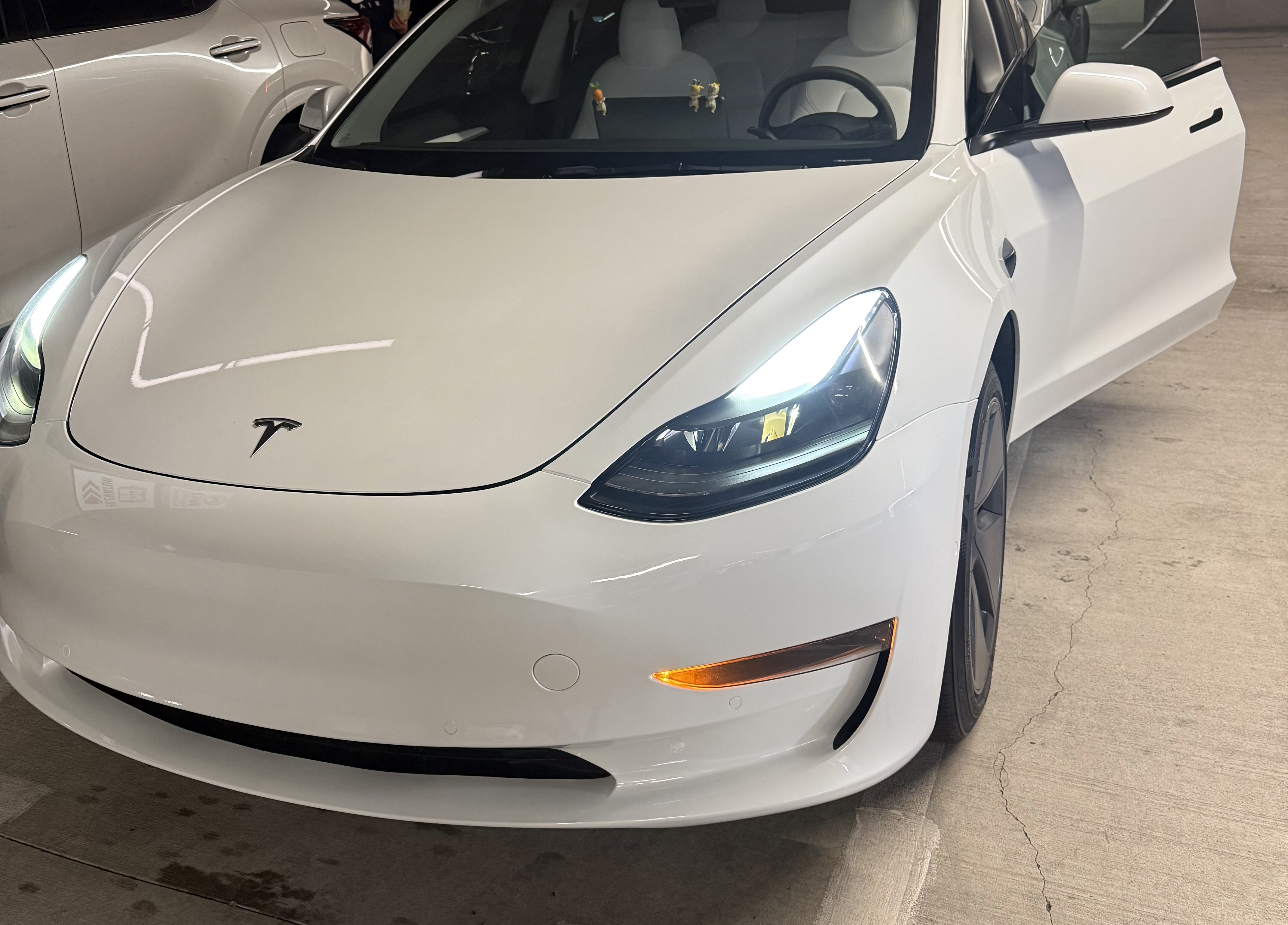 After: white Tesla Model 3 front bumper and fender collision repair