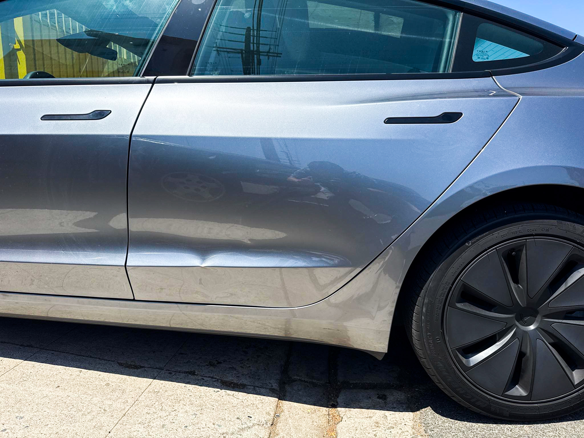 Before: silver Tesla Model 3 rear door dent and crease repair