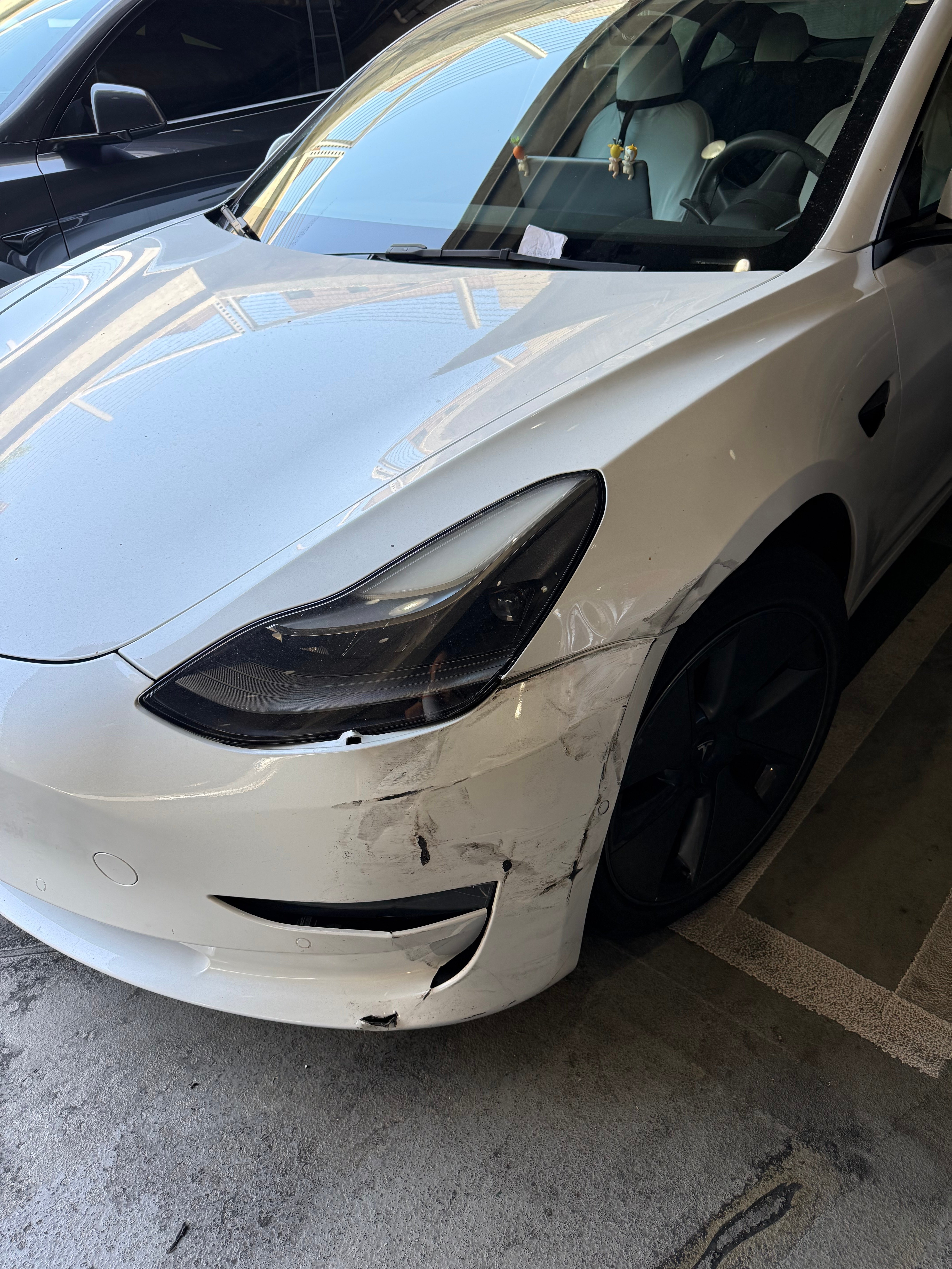 Before: white Tesla Model 3 front bumper and fender collision repair